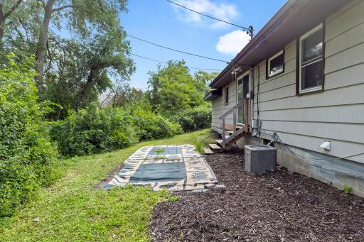 The backyard offers space to add a cozy patio, garden, or outdoor seating area