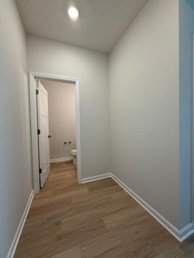 A functional mudroom with space for a bench sits conveniently beside the half bathroom