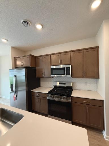 Stainless GE appliances complement the kitchen's modern design