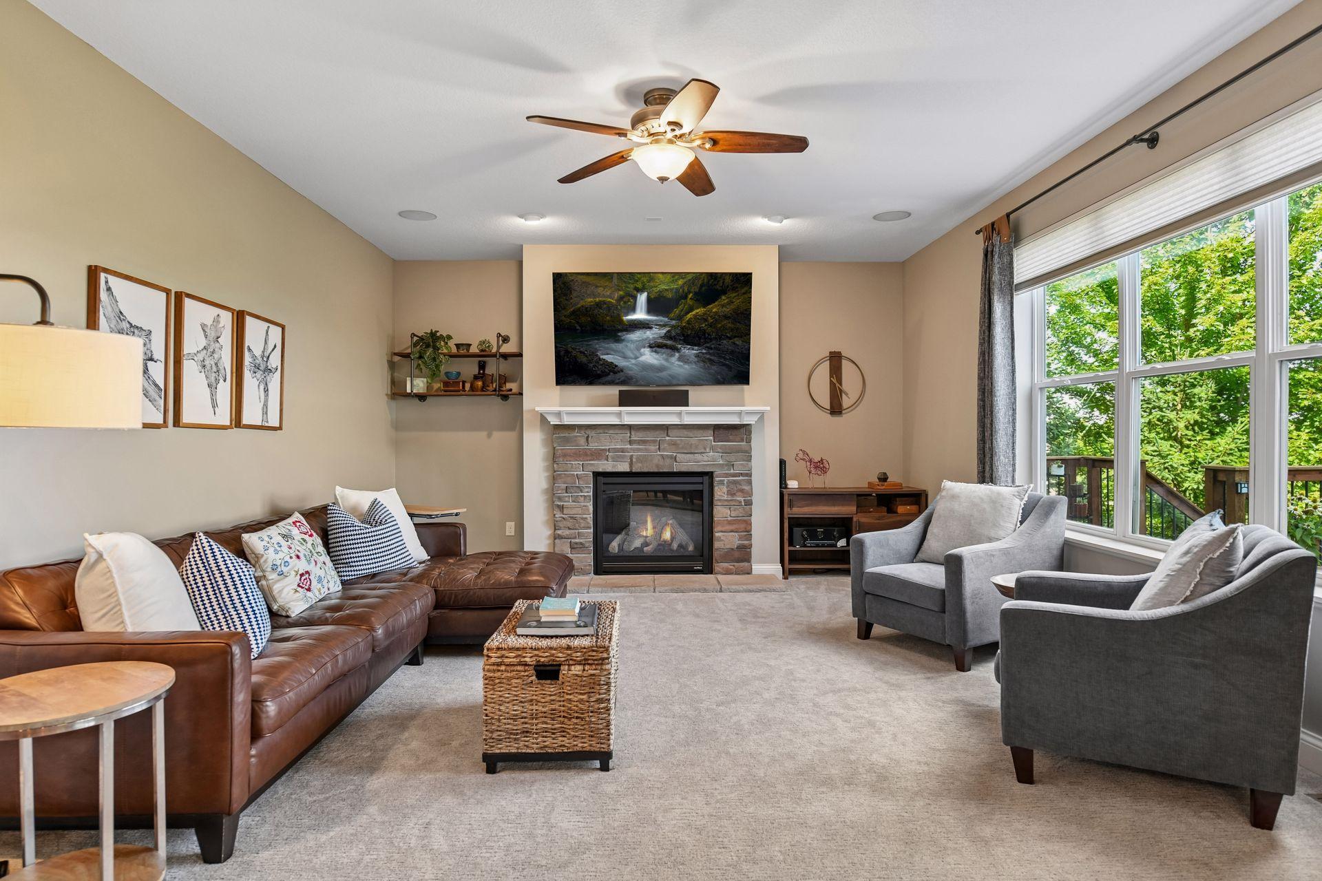 Large family room with gas fireplace, built in speakers and stunning views of backyard.