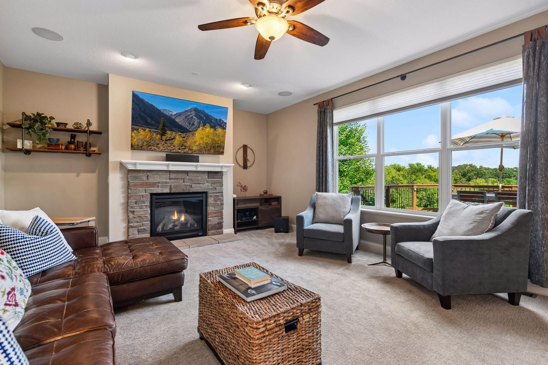 Large family room with gas fireplace, built in speakers and stunning views of backyard.
