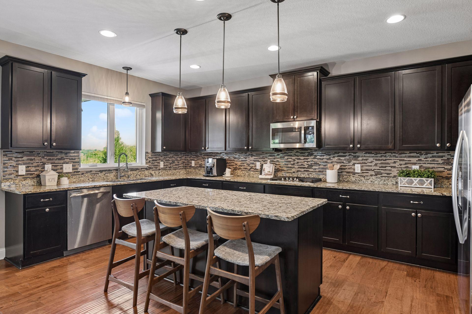 Spacious kitchen with gas cooktop, double ovens and ample cabinetry for entertaining and storage.