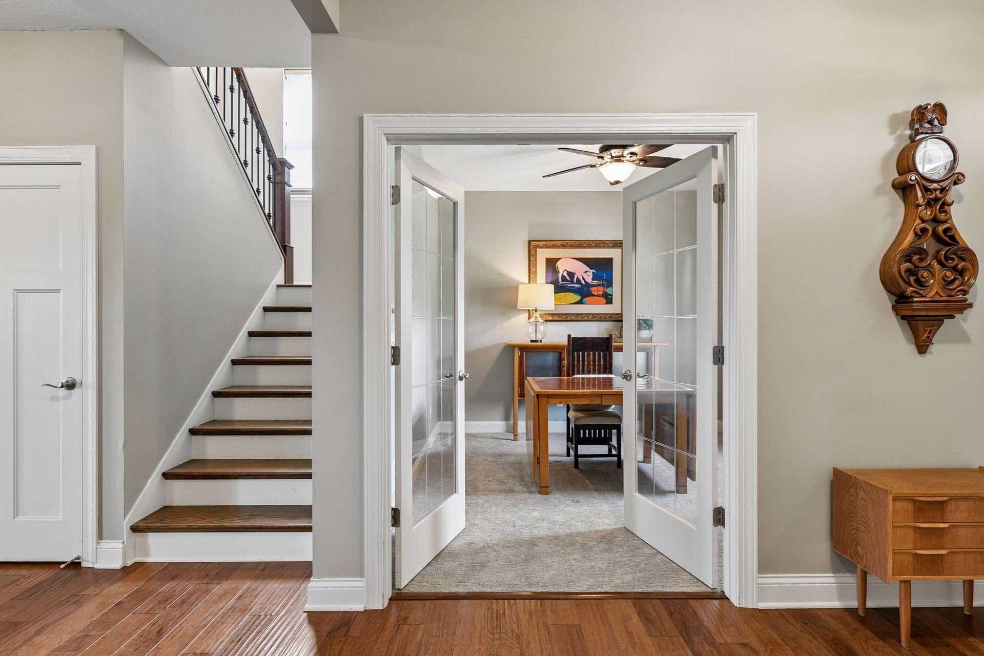 Directly off the front entrance is front office space with double French doors