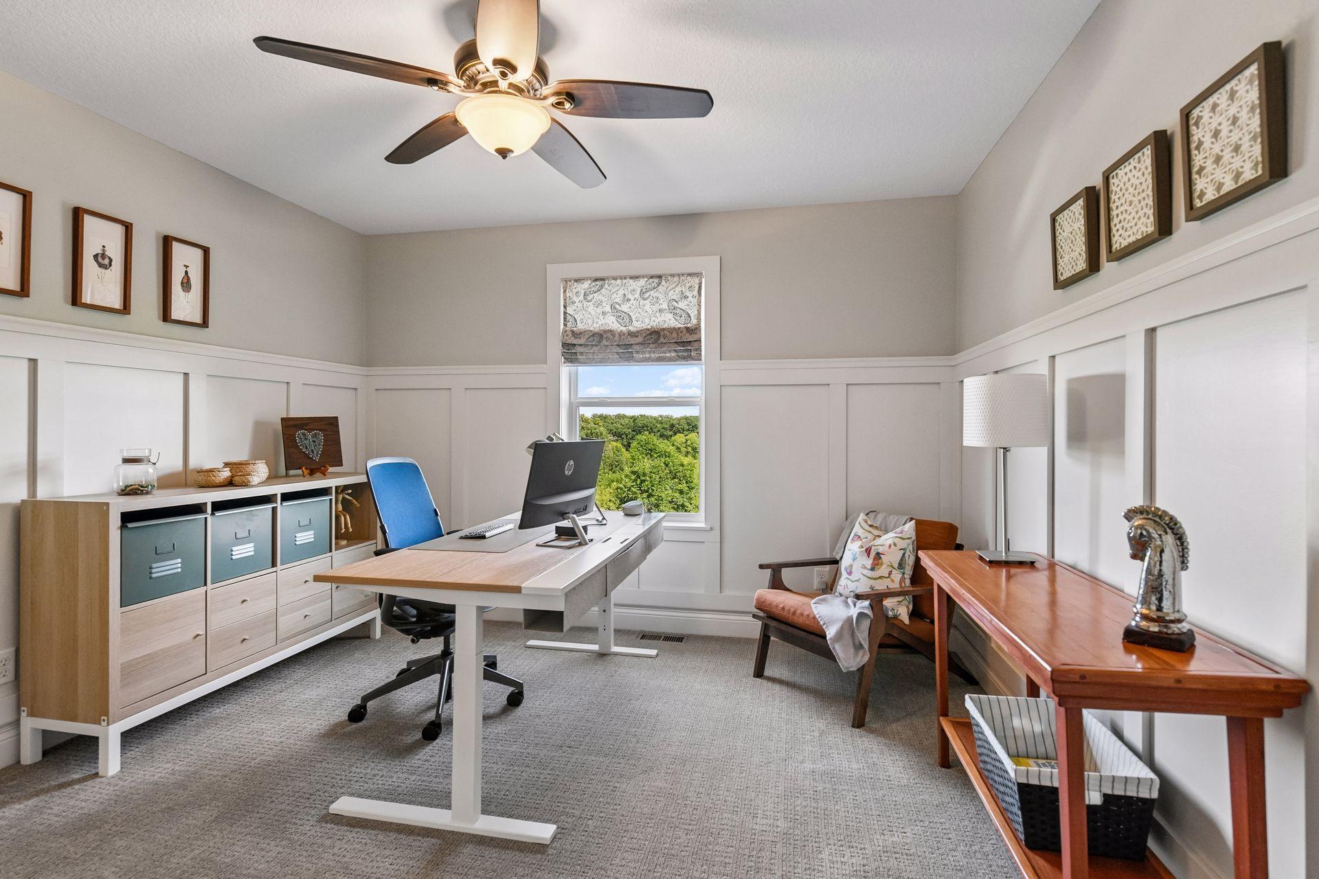 Upper-level room with board-and-batten wall detail, custom blinds and large walk in closet