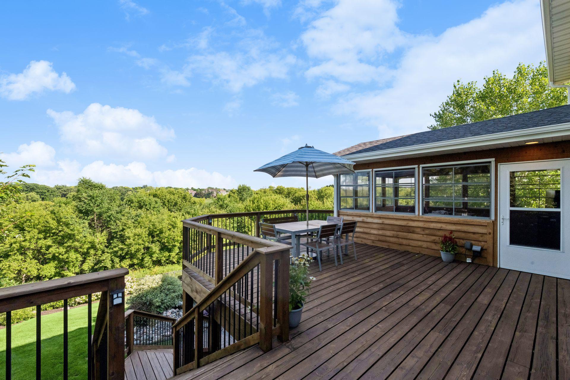 Upper deck with open railing and panoramic preserve views, with room for dining and lounging.