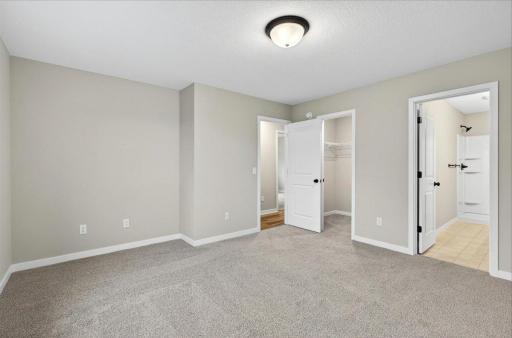 Primary Suite. Photo taken of another home with similar plan and finishes.