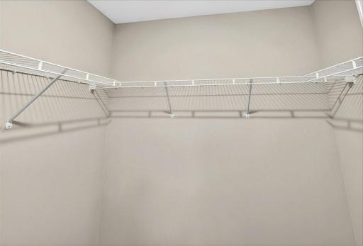 Primary Suite Walk In Closet. Photo taken of another home with similar plan and finishes.