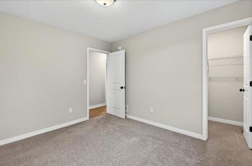 Bedroom 2. Photo taken of another home with similar plan and finishes.