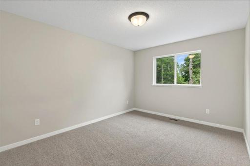 Bedroom 3. Photo taken of another home with similar plan and finishes.