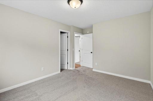 Bedroom 3. Photo taken of another home with similar plan and finishes.