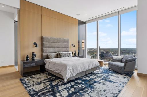 Primary Suite with full wall windows on two sides offering panoramic views of the Minneapolis skyline