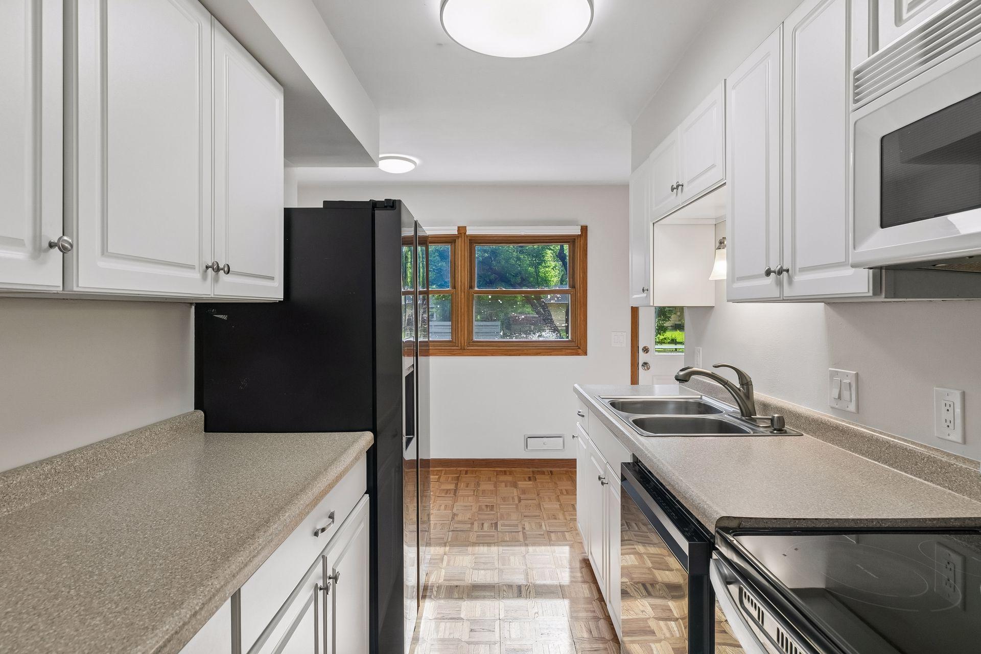 Efficient kitchen with room for breakfast table and newer appliances