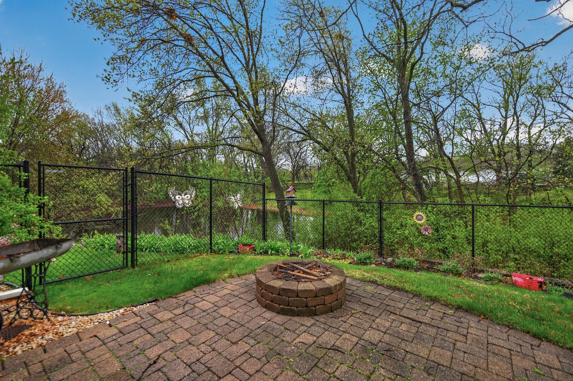 Backyard overlooking wooded area and pond.