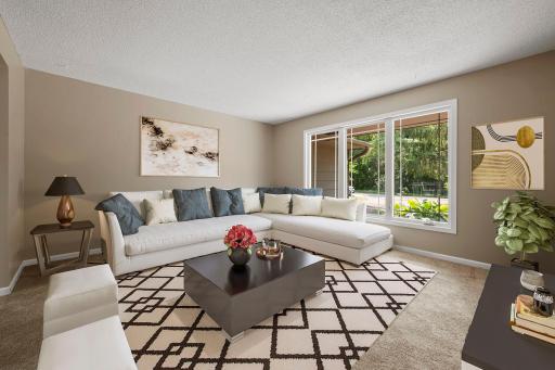 Virtually staged living room off the foyer