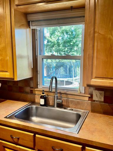Watch the kids from the kitchen sink window while cleaning up.