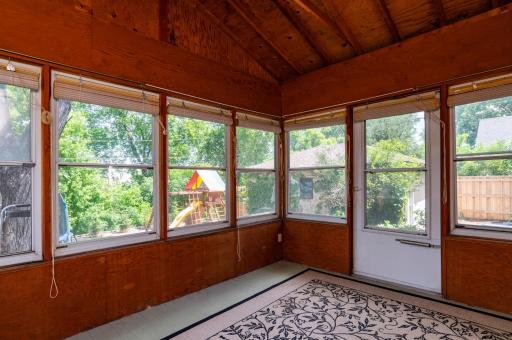 The back screen porch offers views of the back yard without the mosquitos.