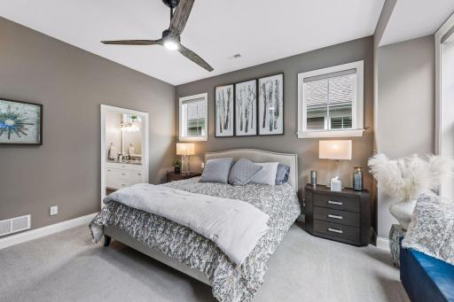 Primary bedroom that is boasted by natural lighting.