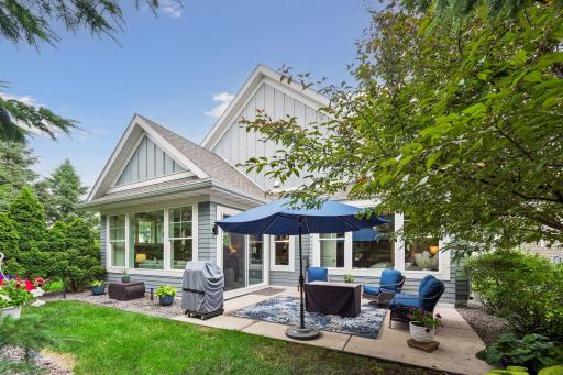 Back view of your home with the patio. Glorious landscaping and seating area.