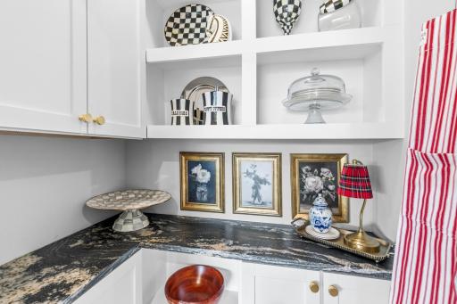 This is the walk-in pantry that has been re-designed with cabinetry and Titanium granite.
