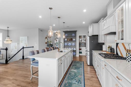 The pantry is located next to the plate wall display and has a pocket door.