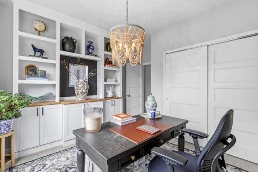 The office has a built-in book shelf and the middle shelf can be pulled out for a desk.