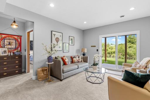 Lower level family room #1 walks out to the patio and fenced backyard. The doorway to the left is bedroom #4.