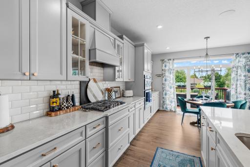 Look at all of the cabinets, countertops, range hood, microwave, wall oven and built-in buffet that cover the entire wall. That was all custom upgrades.