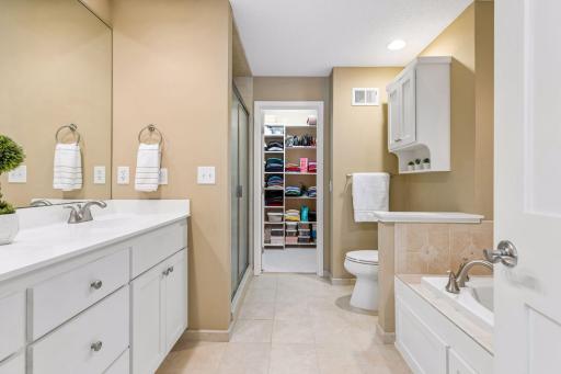 Connected to the primary bathroom is a spacious, custom-designed, walk-in closet.