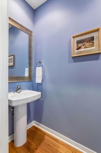 A half-bath powder room is conveniently located on the main floor, beneath the staircase.
