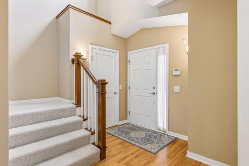 Inside the main entrance door is a generous coat closet and steps up to the second floor bedrooms and laundry room. A high ceiling reflects the natural light.