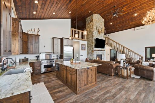 The heart of the lodge features soaring stained Douglas fir ceilings, a floor-to-ceiling stone fireplace, Viking appliances, leathered granite, and custom cabinetry
