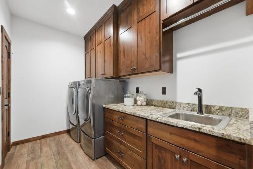 The deluxe laundry room combines functionality with custom storage, making daily living as effortless as it is organized.
