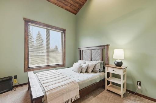 Wake to peaceful views of the surrounding countryside from this spacious and inviting bedroom.