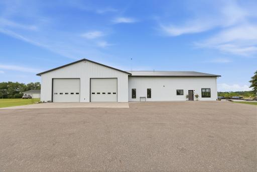 Approximately 3,000 sq. ft. heated attached garage with in-floor heat, floor drains, water, electric, and multiple overhead doors.