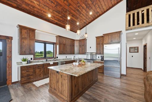 The heart of the lodge features soaring stained Douglas fir ceilings, a floor-to-ceiling stone fireplace, Viking appliances, leathered granite, and custom cabinetry