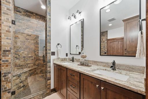 spa-inspired primary bath featuring a copper soaking tub, oversized shower, dual vanities, and private water closet