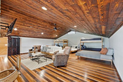 The expansive loft provides additional sleeping accommodations, a cozy fireplace, and panoramic views overlooking the great room and surrounding landscape