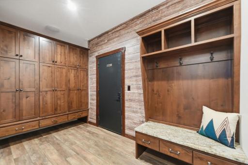 Designed with everyday convenience in mind, the mudroom features extensive storage, multiple closets, and direct access to the heated attached garage.