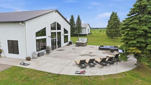 Designed for unforgettable gatherings, the expansive concrete patio seamlessly extends the living space into the outdoors