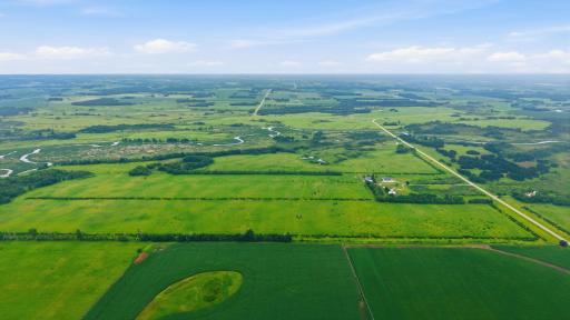 A sweeping aerial view showcases the Long Prairie River and the diverse landscape of woods, grasslands, and waterways that make this nearly 375-acre estate truly one of a kind.