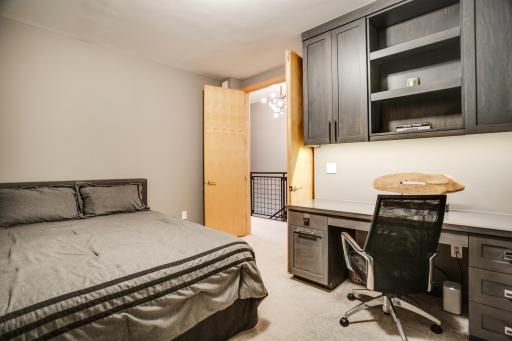 The second bedroom with built-in cabinetry offers additional versatility for an office or guest room.