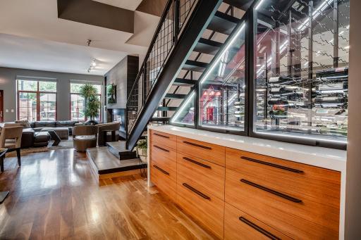 The wine cellar acts as functional art with temperature controls and dramatic lighting.