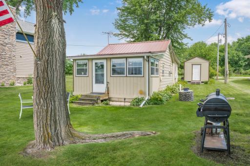 A picture-perfect retreat. The spacious level lot, mature shade trees, and charming cabin create the ideal setting for relaxing, entertaining, and making lifelong memories on the lake.