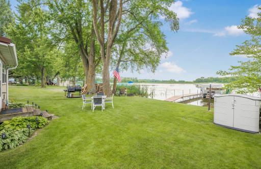 Imagine weekends spent right here. A rare level lakeside yard offers plenty of room for yard games, grilling, relaxing in the shade, or gathering with family and friends just steps from the water.