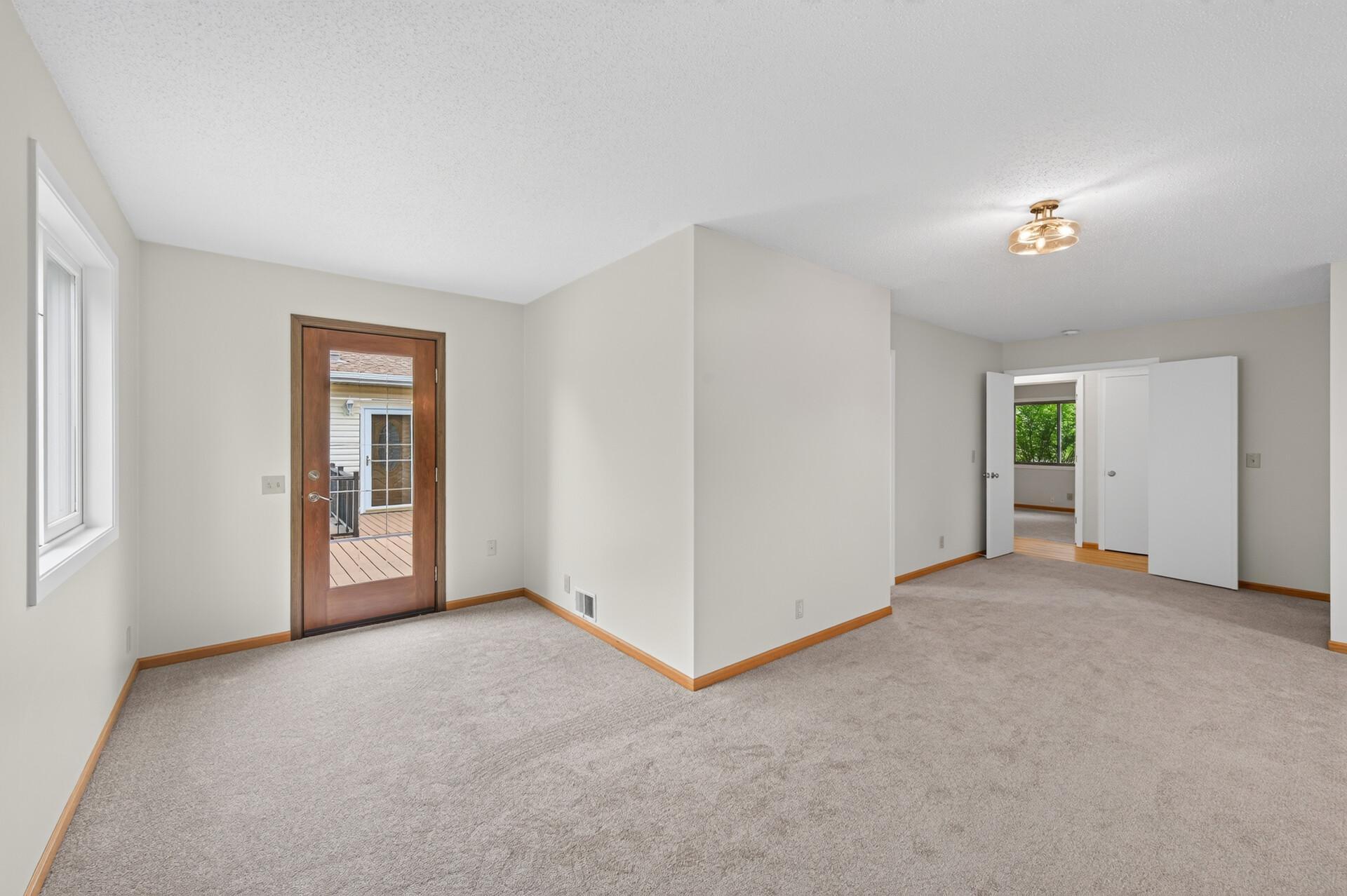 Primary bedroom toward deck and hallway
