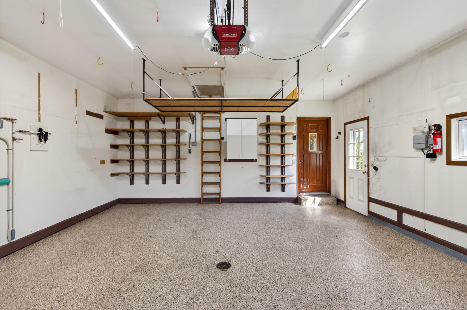 Power lift for attic storage where the laddar is. Other storage shelving included