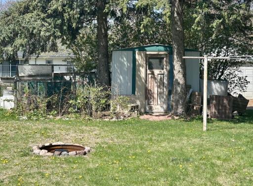 Backyard offers a built-in firepit and an 8 x 10 shed -- NOTE: Chickens and coop will NOT stay. The rasperried will - get them quick!!