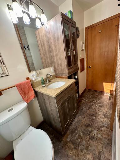 You will appreciate the rich wood tones of the cabinetry & hard surface countertop with undermount sink.