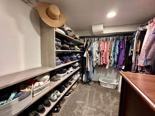 The barn door leads to this massive walk-in closet featuring built-ins for all your storage needs.