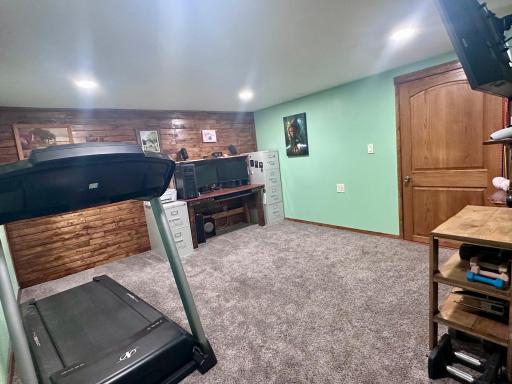 Lower-level family room... doubles as office & workout space currently. Times are a changing! :)